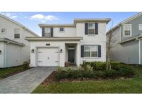 Charming two-story home with well-kept landscaping, paver driveway and a one car garage at 1646 Moon Valley Dr, Davenport, FL 33896