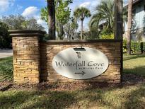Waterfall Cove at Winter Park community sign on a stone pillar amidst lush greenery at 1695 Lee Rd # E103, Winter Park, FL 32789