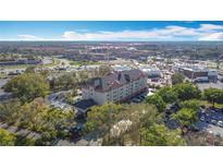 An aerial view shows the property with surrounding businesses and roads in a vibrant neighborhood at 3000 Maingate Ln # 205, Kissimmee, FL 34747
