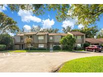 Well-maintained townhouse complex featuring a lush green landscape and ample parking space for residents and visitors at 406 Oak Haven Dr # 406, Altamonte Springs, FL 32701