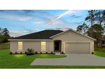 Charming single-story home featuring a two-car garage, well-maintained lawn, and neutral stucco exterior at 43 Peterlee Ct, Kissimmee, FL 34758