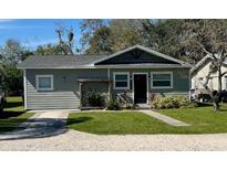 Charming single-story home with well-maintained lawn, gravel driveway, and neutral-toned siding at 430 Connecticut Ave, St Cloud, FL 34769