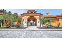 Stunning entrance to the clubhouse with meticulously landscaped grounds and decorative architectural features at 6153 Metrowest Blvd # 103, Orlando, FL 32835