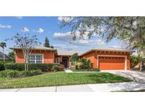 Charming single-story home with a well-maintained lawn and beautiful landscaping at 651 Highlands Hammock Dr, Poinciana, FL 34759