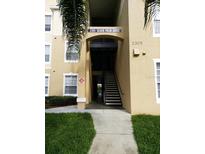 Building exterior featuring well-maintained landscaping and visible unit address at 2305 Silver Palm Dr # 102, Kissimmee, FL 34747