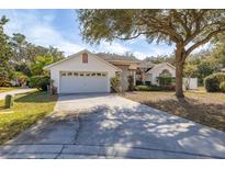 Charming single-story home with an attached two-car garage and mature landscaping in a serene neighborhood at 248 Breezy Oaks Ct, Davenport, FL 33896