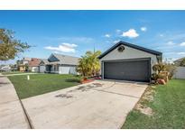 Beautiful single-story home boasting a well-kept lawn, two-car garage, and driveway at 3111 Turnberry Blvd, Kissimmee, FL 34744