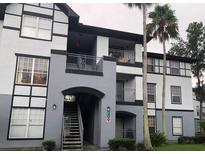 Three-story apartment building showcasing an elegant facade with balconies and well-maintained landscaping at 3712 Castle Pines Ln # 4126, Orlando, FL 32839
