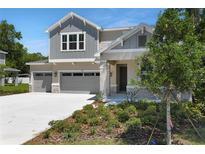 Charming two-story home with a three-car garage, landscaped yard, and stone accents at 3749 Deer Ridge Dr, Mount Dora, FL 32757