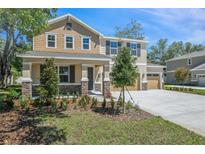 Charming two-story home featuring mixed siding, stone accents, a well-manicured lawn, and a two-car garage at 3757 Deer Ridge Dr, Mount Dora, FL 32757