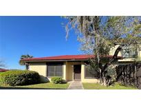 Inviting front exterior with a red tile roof and decorative tree providing shade at 433 Hunter Circle Cir, Kissimmee, FL 34758