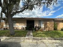 Charming single-story home with a well-manicured lawn and mature tree, offering shade and curb appeal at 996 Dolphin Dr, Winter Garden, FL 34787