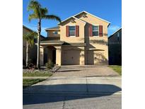 Charming two-story home with brick paved driveway and well-manicured landscaping at 2777 Monticello Way, Kissimmee, FL 34741