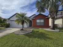Charming single-Gathering home with a well-manicured lawn and a lovely palm tree at 2812 Tower Rock St, Kissimmee, FL 34758