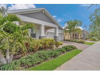 Charming home featuring lush landscaping, a brick driveway, and an inviting covered porch at 2884 Nottel Dr, St Cloud, FL 34772