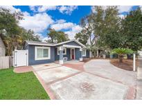Charming single-story home with a well-manicured lawn and a welcoming red front door at 2919 Sylvan Ave, Orlando, FL 32806