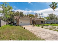 Charming single-story brick home featuring an attached two-car garage and well-maintained front yard at 3189 Saint James Ave, Deltona, FL 32738