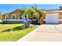 Charming single-story home featuring a well-manicured lawn and a convenient driveway leading to the garage at 602 N Delmonte Ct, Kissimmee, FL 34758