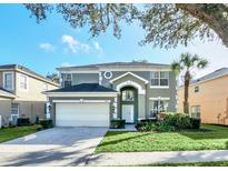 Charming two-story home with a well-manicured lawn and attached two-car garage at 8462 Secret Key Cv, Kissimmee, FL 34747