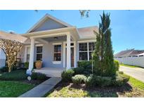 Charming single-story home with a welcoming front porch and well-manicured landscaping at 14620 Golden Rain Tree Blvd, Orlando, FL 32828