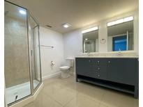 Modern bathroom featuring a double sink vanity and a glass enclosed shower at 175N Pearl Lake Cswy # 114, Altamonte Springs, FL 32714