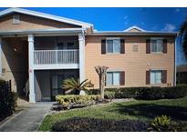 Charming townhouse exterior with a well-manicured lawn and balcony at 175N Pearl Lake Cswy # 114, Altamonte Springs, FL 32714