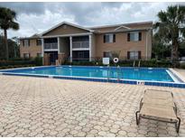 Community pool with blue tile and chaise lounge at 175N Pearl Lake Cswy # 114, Altamonte Springs, FL 32714