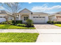 Charming single-story home boasting a manicured lawn, paver driveway, and an attached two-car garage at 4918 Drawdy Ct, St Cloud, FL 34772