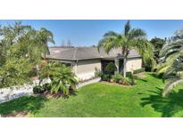 Charming single-story home with a well-manicured lawn and lush landscaping, creating inviting curb appeal at 555 Presido Park Pl, Kissimmee, FL 34759
