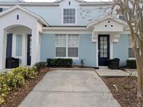 Charming two-story townhomes with light blue exterior paint and well-maintained landscaping at 7660 Otterspool St, Kissimmee, FL 34747