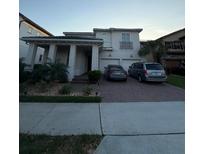 Charming two-story home with a well-maintained lawn, two-car garage, and brick paved driveway at 8289 Topsail Pl, Winter Garden, FL 34787