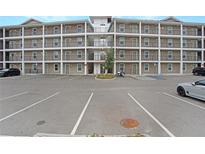 Apartment building with multiple stories, balconies, and a spacious parking area for residents and guests at 841 Retreat Blvd # 101, Davenport, FL 33897
