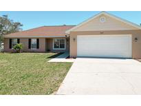Charming one-story home featuring a two-car garage, well-maintained lawn, and inviting front entrance at 15069 Sw 29Th Avenue Rd, Ocala, FL 34473