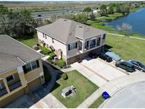 Beautiful aerial view of townhome near a lake and highway offering a scenic view and convenient location at 2120 Betsy Ross Ln, St Cloud, FL 34769