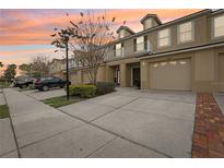 Inviting townhome with well-maintained landscaping, private balconies, and attached garages at 3008 Thornton Dr, Kissimmee, FL 34741