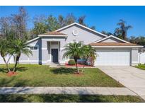 Charming single-story home with a well-manicured lawn and beautiful palm trees in a bright setting at 3123 Fairfield Dr, Kissimmee, FL 34743