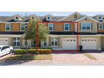 Charming townhome with a brick driveway and a one-car garage at 521 Pacito Way, St Cloud, FL 34769