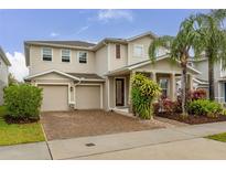 Charming two-story home featuring a two car garage and beautifully landscaped yard at 5685 Surprise Lily Dr, Winter Garden, FL 34787