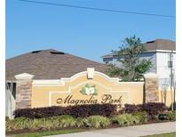 Magnolia Park sign with plants and stone pillars at 676 Tanaro Ln, Haines City, FL 33844