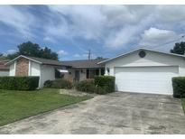Charming single-story home features a brick accent, well-manicured lawn, and attached garage at 706 Francis St, Kissimmee, FL 34741