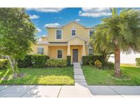 Inviting two-story home featuring a well-maintained lawn, lush landscaping, and a welcoming facade at 1000 Seburn Rd, Apopka, FL 32703