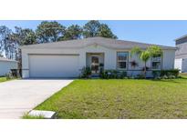 Charming single-story home featuring a well-maintained lawn and attached two-car garage at 151 Flatfish Ct, Poinciana, FL 34759