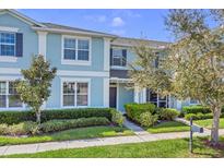 Charming blue two-story townhome with well-maintained landscaping and a welcoming entrance at 1578 Softshell St, St Cloud, FL 34771