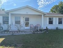 Charming single story home with a well manicured lawn, cozy porch, and inviting curb appeal at 268 Florida Pkwy, Kissimmee, FL 34743