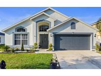 Charming single-story home with a well-manicured lawn and a two-car garage at 3686 Ricky Ln, St Cloud, FL 34772