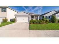 Charming single-Gathering home features a well-manicured lawn, inviting facade, and an attached two-car garage at 4479 Blue Rock Dr, Sanford, FL 32771