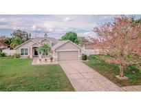 Charming single-story home features a well-manicured lawn, a two-car garage and mature landscaping at 4809 Jeanette Ct, St Cloud, FL 34771