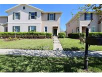 Charming townhome with lush landscaping and a well-manicured lawn welcomes you home at 1615 Reflection Cv, St Cloud, FL 34771