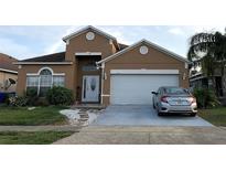 Charming two-story home featuring an attached two-car garage and well-maintained front yard at 2244 Mallard Creek Cir, Kissimmee, FL 34743