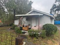 Charming single-story home with a covered porch, mature landscaping, and vintage charm at 2316 W Parker St, Lakeland, FL 33815